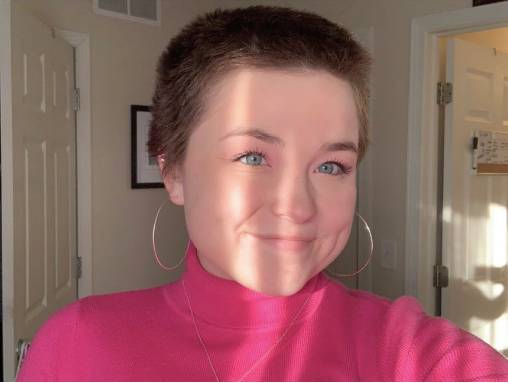 Camryn Lane smiling with short hair and a pink shirt
